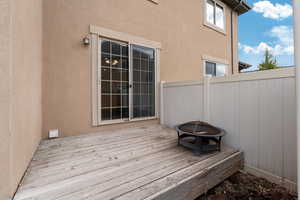 Wooden deck featuring a fire pit