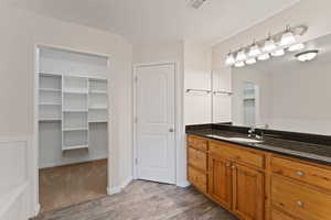 Bathroom with hardwood / wood-style floors and vanity