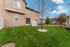 Rear view of house with a lawn