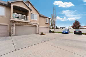 View of front of house with a balcony and a garage