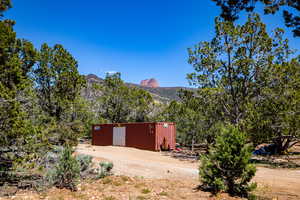 View of yard with a mountain view and an outdoor structure