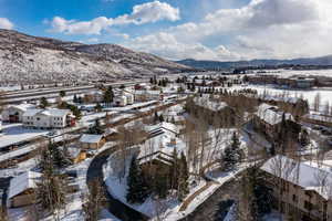 Snowy aerial view featuring a mountain view