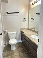 Bathroom with vanity, a bathtub, and toilet