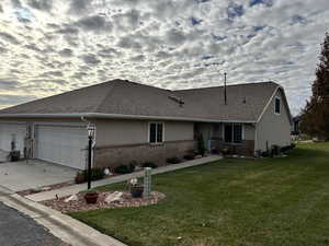 Single story home featuring a lawn, central AC, and a garage