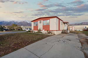 Property exterior at dusk with a mountain view