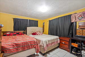 Bedroom with a textured ceiling