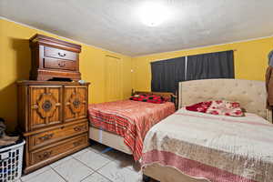 Bedroom with a textured ceiling