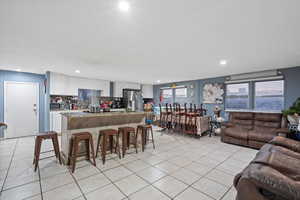 Tiled living room featuring a wealth of natural light