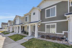 View of front of house with a porch and a front lawn