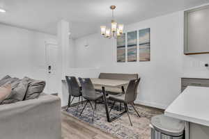 Dining room featuring light hardwood / wood-style floors and a notable chandelier