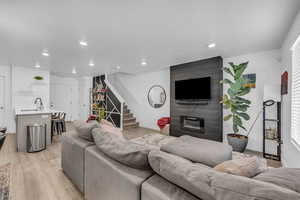 Living room featuring sink and light hardwood / wood-style floors