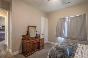 Carpeted bedroom with ceiling fan