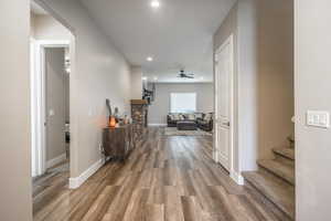 Hallway with hardwood / wood-style flooring