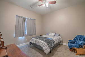 Bedroom featuring light colored carpet and ceiling fan