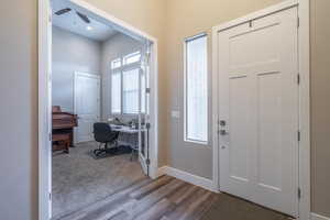 Entryway featuring ceiling fan, a healthy amount of sunlight, and light hardwood / wood-style floors