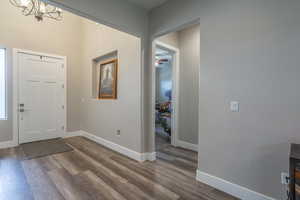 Foyer featuring hardwood / wood-style flooring and a notable chandelier