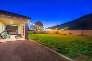 Yard at dusk with a patio area