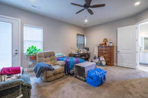 Interior space with light carpet and ceiling fan