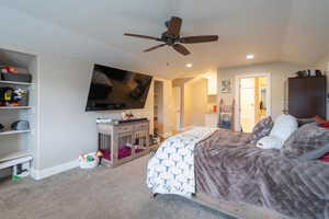 Carpeted bedroom with vaulted ceiling and ceiling fan