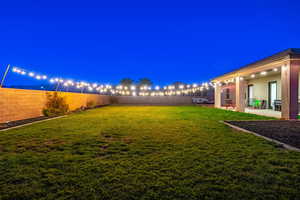 Yard at twilight with a patio area