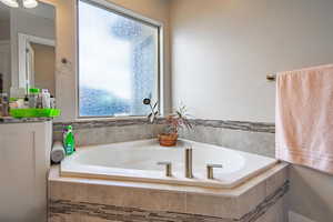 Bathroom featuring tiled bath