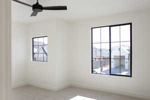 Unfurnished room featuring light colored carpet and ceiling fan