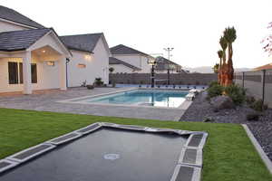 View of swimming pool with a yard