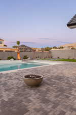 View of pool at dusk