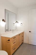 Bathroom featuring tile patterned floors and vanity