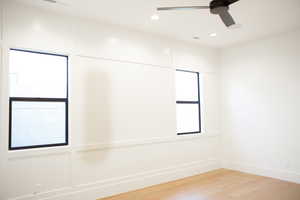 Spare room with ceiling fan and light wood-type flooring