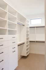 Spacious closet with light carpet