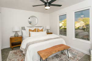 Bedroom featuring carpet flooring, ceiling fan, and a textured ceiling