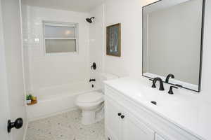 Full bathroom with vanity, tub / shower combination, and toilet