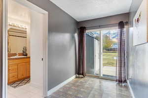 Foyer entrance featuring a textured ceiling and sink