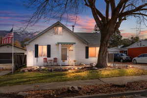 Bungalow-style home with a mountain view and a yard