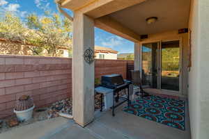 View of patio featuring grilling area and sliding glass door from living room.