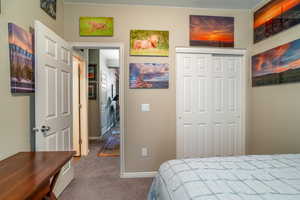 Carpeted bedroom #3 with a closet