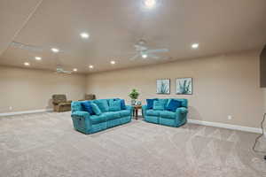 Carpeted living room with ceiling fan