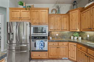 Kitchen with decorative backsplash and stainless steel appliances