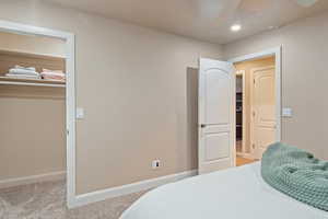 Bedroom featuring light colored carpet and a textured ceiling