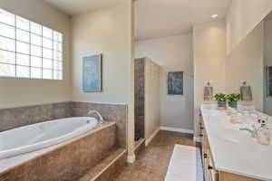 Bathroom featuring tile patterned flooring, vanity, and independent shower and bath