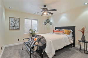 Bedroom featuring ceiling fan and carpet floors