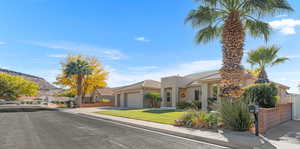 View of front of property featuring a front yard and a garage