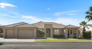 View of front of home featuring a front yard and a garage