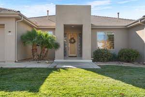 Property entrance featuring a lawn