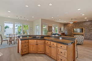 Kitchen with a breakfast bar, a kitchen island, and light hardwood / wood-style flooring