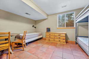 Tiled bedroom with crown molding