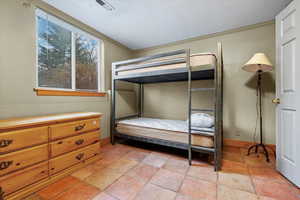 Bedroom with a textured ceiling and ornamental molding