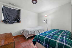 Bedroom featuring a textured ceiling and tile patterned floors