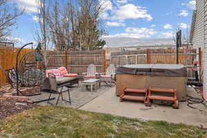 View of patio with an outdoor hangout area and a hot tub